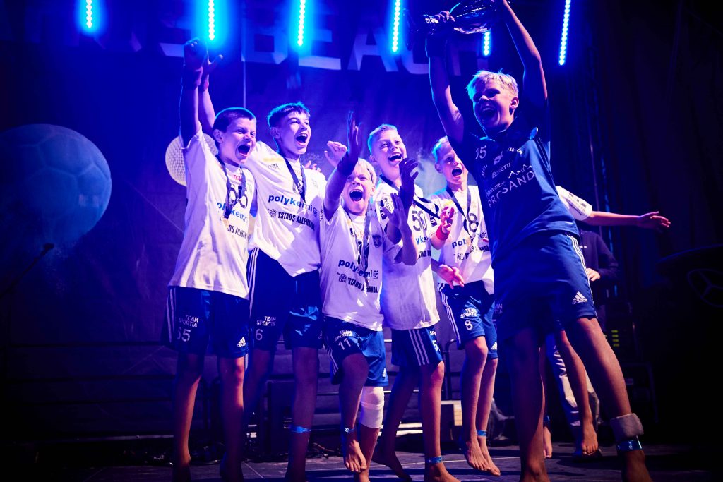 Pojklag tagit emot vinstpokal på scen Åhus Beachhandboll festival
